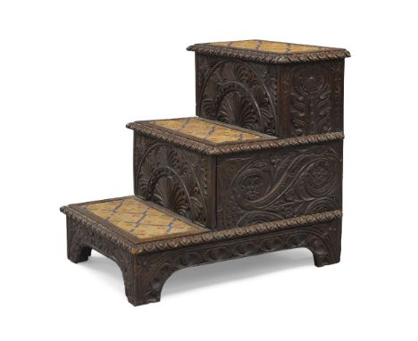 A set of Victorian oak library steps, In the Gothic taste, carved in relief with floral scrolls and geometric patterns, egg a