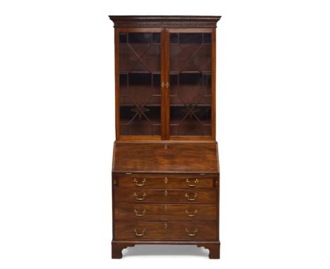A George III mahogany bureau bookcase, circa 1760, the dentil moulded cornice above blind-fret carved frieze and pair of astr