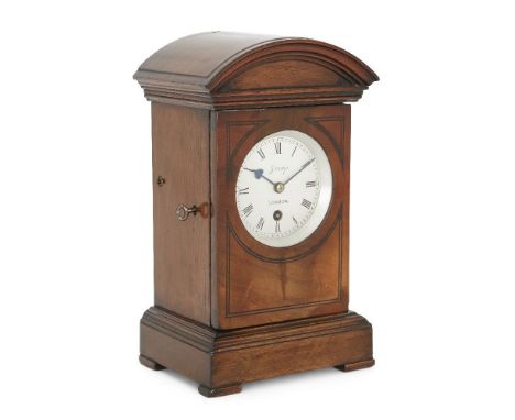 A mahogany mantel timepiece, late 19th/early 20th century, the case with arched moulded cornice, above ebony line inlaid fron