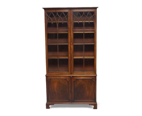 A George III mahogany bookcase, the moulded cornice above pair of glazed doors, enclosing four adjustable shelves, above pair
