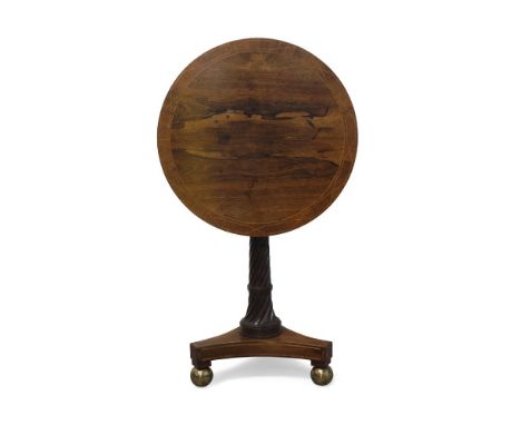 A Regency rosewood tilt-top tripod table, the circular crossbanded and string inlaid top above wrythen twist central column t