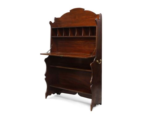 An Edwardian mahogany bureau cabinet, with shelf above pigeon holes and fall front writing surface over two open shelves, on 