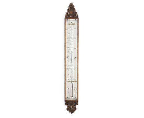 An early Victorian mahogany wall thermometer, mid 19th century, the glazed case with carved cartouche finial and foliate term