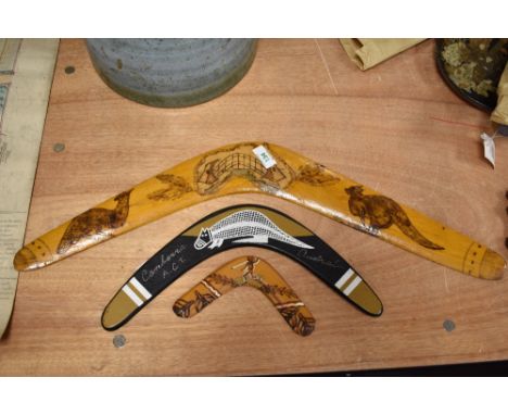 Three Australian aboriginal carved boomerangs, of graduating sizes, the largest illustrated with a kangaroo and cassowary, me