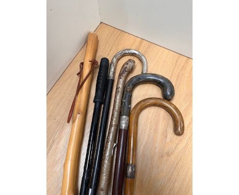 A selection of walking sticks, to include a stick with bone handle and silver hallmarked collar, and others with turned wood 