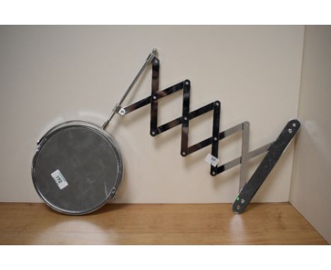 A chrome metal shaving mirror with concertina bracket