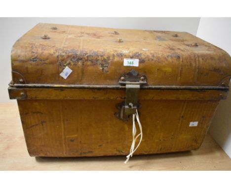 An early 20th Century brown painted tin trunk of domed form, measuring 36cm x 56cm x 34cm overall