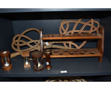 A mixed lot of treen egg timers, a shelf and two carpet beaters.
