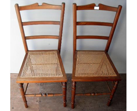 A pair of late Victorian walnut-framed bedroom or occasional chairs with rattan seats, ladder-back supports on turned legs
