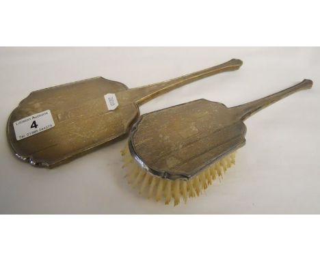 Silver mirror and brush