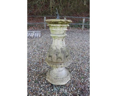 A stone sundial, the later dial engraved 'J Fowler, London', on a 19th century baluster shaped base, carved with foliage and 