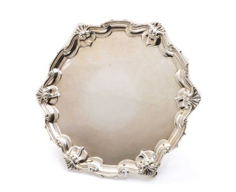 A silver salver, by William Hutton &amp; Sons Ltd, London 1908, of circular form, the scalloped border with shell and scroll 