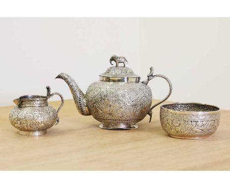 An Indian silver tea service, late 19th to early 20th century, comprising a teapot with elephant finial, 13.5cm high, milk ju