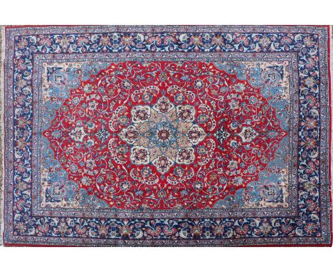 An Isfahan carpet, 20th Century, the red ground with scrolling foliate motifs within a banded border, 312cm x 383cmCondition 