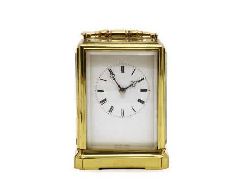 A late 19th century French brass carriage clock, with bevelled glasses, striking the half hours on a bell, backplate stamped 