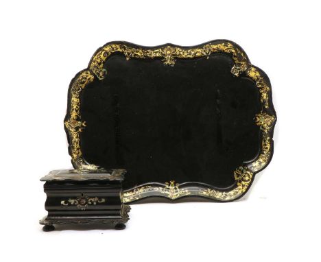 A Victorian mother of pearl inlaid paper mache tea caddy, the scalloped rectangular top enclosing compartmental interior on s