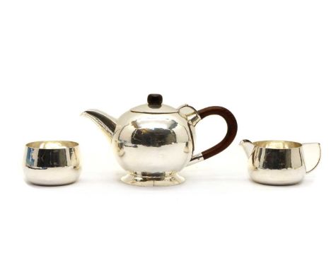 A mid-century faintly planished three piece tea service, by B.C.A, London 1958, in the manner of Christopher Dresser, consist
