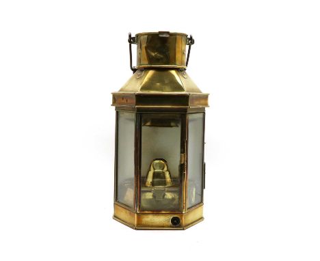 A WWI brass bulkhead lantern, manufactured by Bullpit &amp; Sons Ltd. Birmingham, dated 1917, with a wooden carrying handle, 