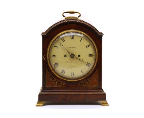 A Regency mahogany bracket clock, the case with fish scale grille sides and engraved door grilles, with carrying handle to a 