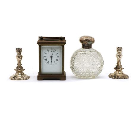 A silver topped cut glass perfume bottle, Birmingham 1903, 12.5cm high, together with a pair of silver plated tapersticks 9 c