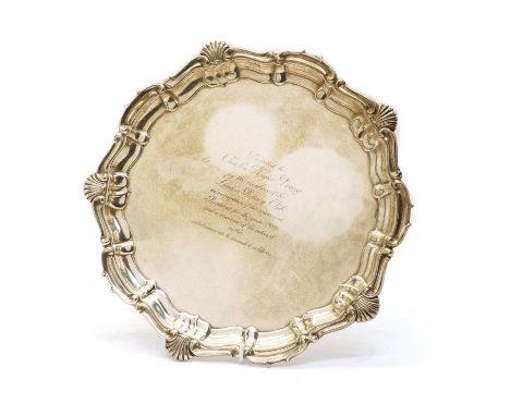 A silver salver, by the Harrison Brothers &amp; Howson, Sheffield 1915, the scalloped border with shell and scroll decoration