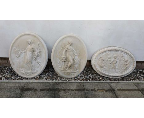 A pair of composite stone oval panels, of recent manufacture, each cast in relief with a classical figure, 63cm wide, 80cm hi