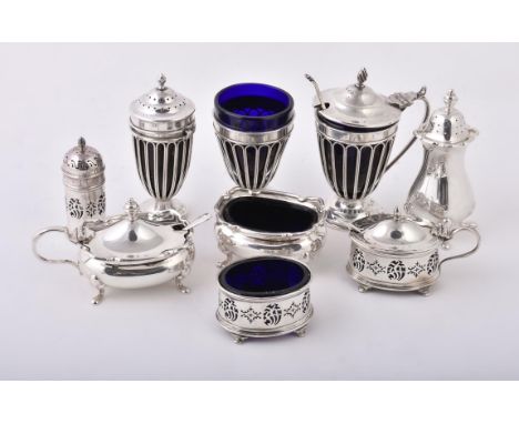 
	
		An Edwardian silver three piece cruet set by Haseler Brothers, Chester 1907, the mustard with a cone finial to the domed