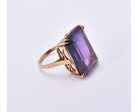 
	
		A 1970s synthetic colour change sapphire dress ring, the step cut colour change synthetic sapphire within eight claw set