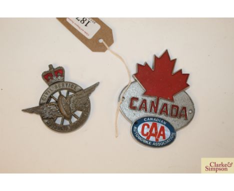 A Canada Automobile Association car badge and a Civil Service car badge 