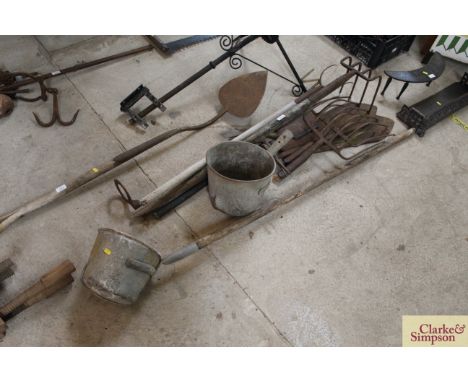 Two hay knives; a long handled scoop; scoop end, stirrup pump and various other tools