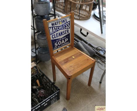 A chair with a Watsons Matchless double sided enamel advertising sign as the back