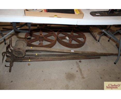 A quantity of long handled tools including a rake, hoes, chrome, and a metal bound wooden mallet