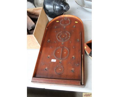 An early Bagatelle board with push stick and balls