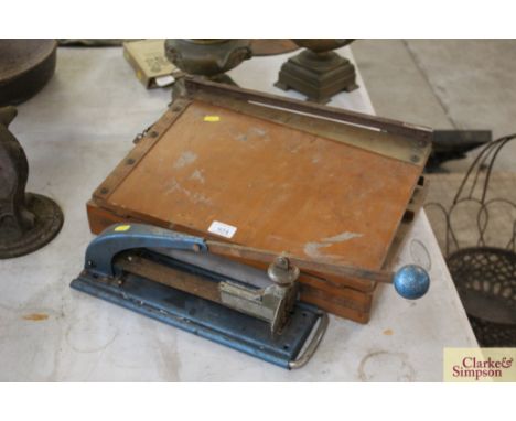A large stapler and a guillotine 