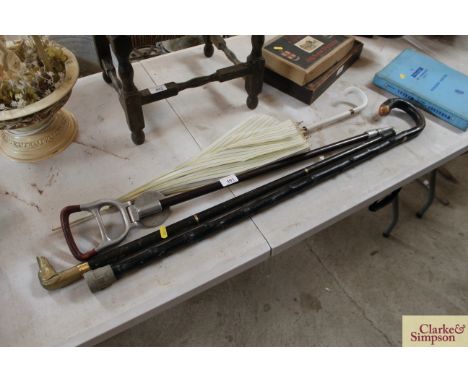 A shooting stick; two walking sticks and a lady's umbrella