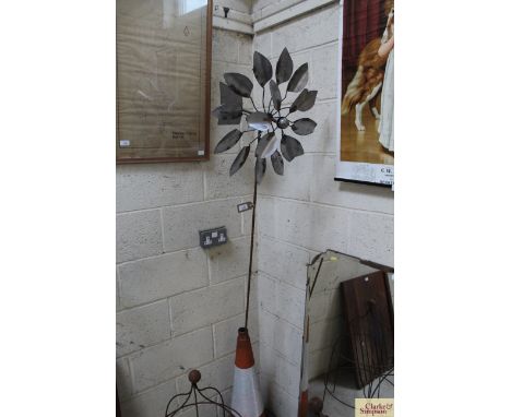 A metal wind powered garden weather vane