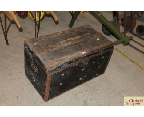 A large wooden bound travelling trunk with carrying handles 