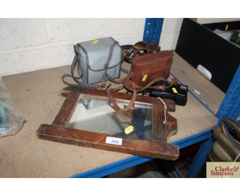 An Agfa camera; a Kodak camera; an Olympus camera; another in leather carrying case and a pine framed wall mirror