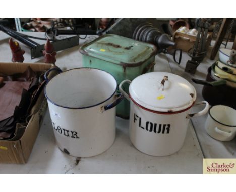 A circular enamel Flour bin with lid, another Flour bin without lid, and a green enamel Bread bin with lid