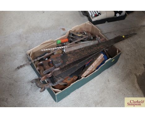 A box of tools including various hand saws, pulley etc. 