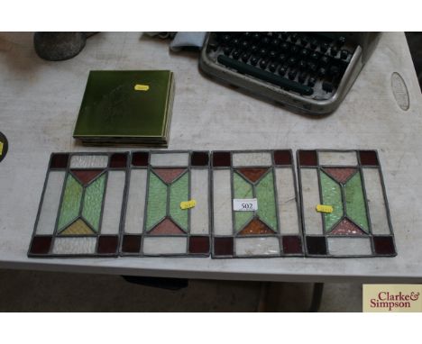 Four coloured glass leaded light panels and four green ceramic tiles