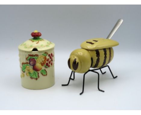 A Wilkinson pottery Clarice Cliff style conserve jar with lid twinned with a honey pot stylised as a bee
