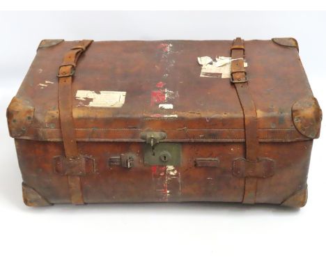 An antique leather travelers trunk, 860mm wide x 515mm deep x 330mm high