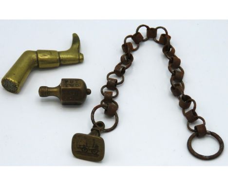 A novelty late Victorian brass leg vesta, a railway steam engine seal & chain & an antique gaming spinning top