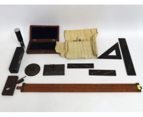 A sliding boxwood Gunter's rule, two cast iron paperweights, various draftsman instruments & tools