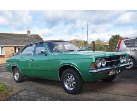 A 1975 Ford Cortina Mk III 2 litre XL automatic, registration number KCB 880P, green.  Once a very familiar site on British r