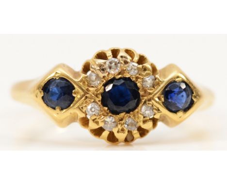 An 18ct gold sapphire and diamond dress ring, three 3mm sapphires surrounded by old cut diamonds, Chester 1915, O, 3.2g