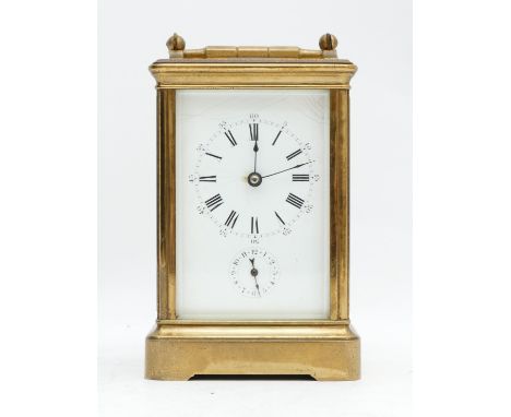 An early 20th century brass alarm carriage time piece, white enamel dial with Roman numerals, the movement striking on a bell