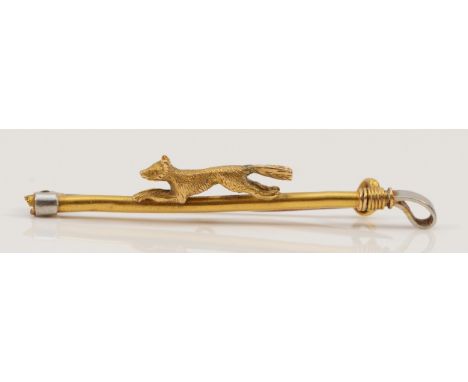 A 15ct gold antique fox hunting brooch, a small fox running on top of a riding crop, the crop handle appears missing, 45mm ac