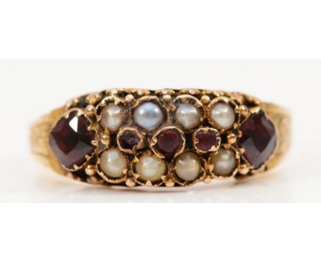 A 15ct gold antique garnet and seed pearl dress ring, Birmingham 1878, engraved pattern around the whole band, P, 2.6g